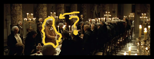 Dinner scene from The Duchess movie with the macaroni character surrounded by men in dark clothes